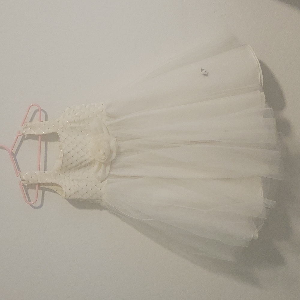 Beautiful cream-colored, formal, sleeveless dress